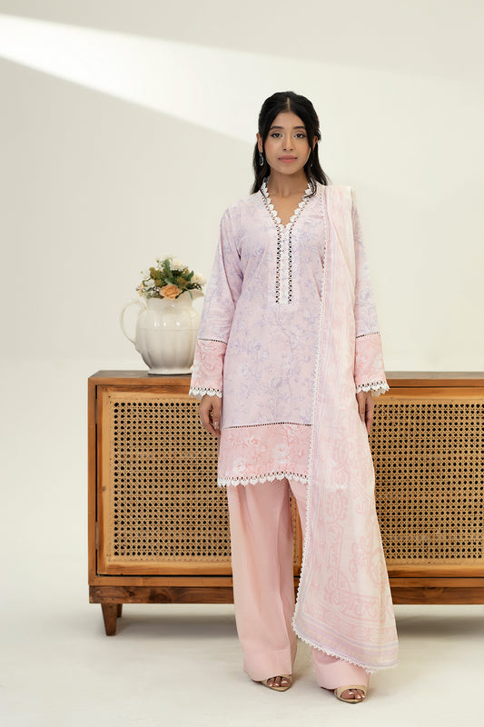 Woman in a light pink traditional outfit standing in front of a wooden cabinet with a white background