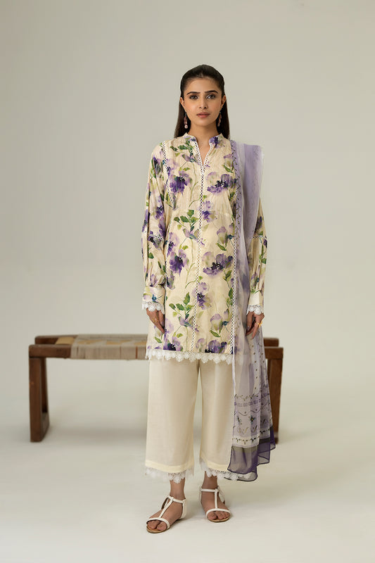 Woman wearing a floral kurta with white pants and a matching dupatta on a plain background