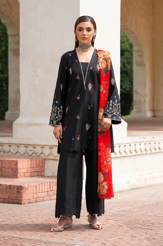 A woman wearing a black ensemble with delicate embroidery and a bold red digital printed chiffon dupatta.