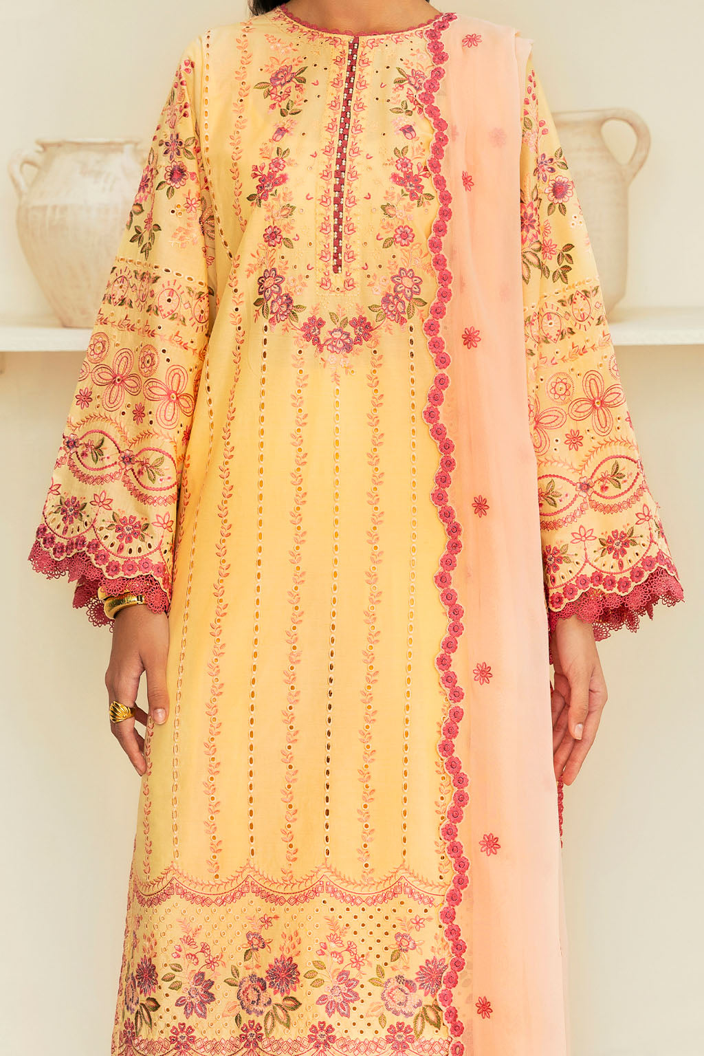 woman wearing a traditional yellow dress with intricate embroidery