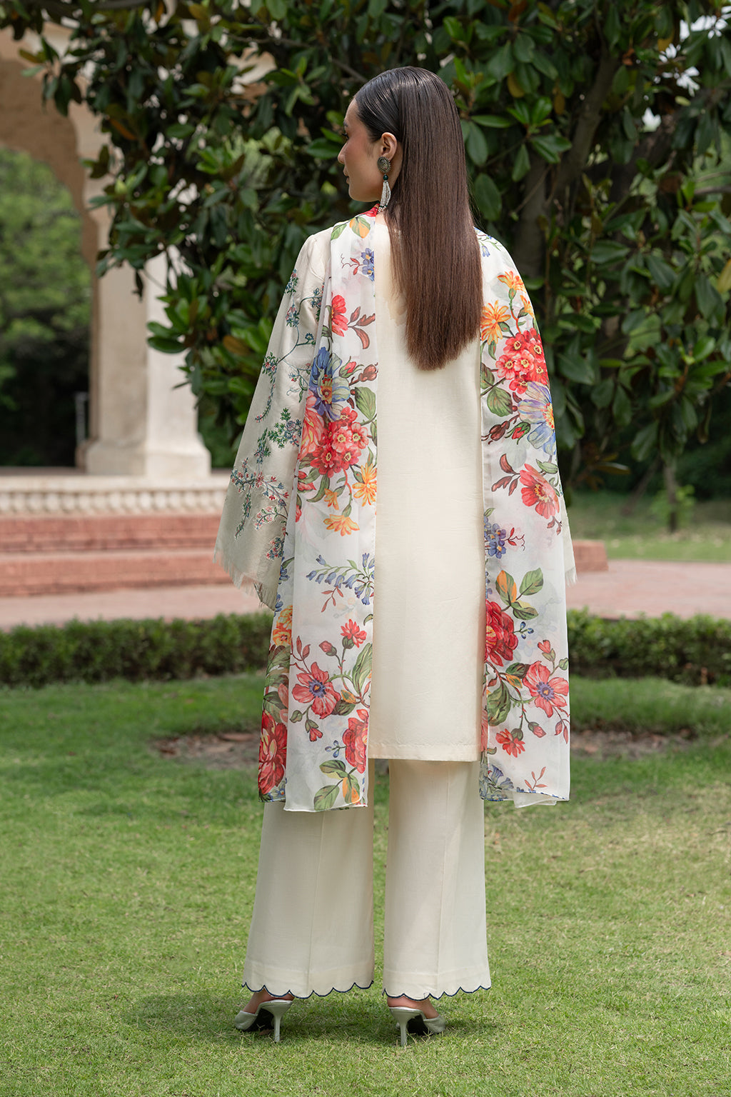Person wearing a floral kimono in a garden setting