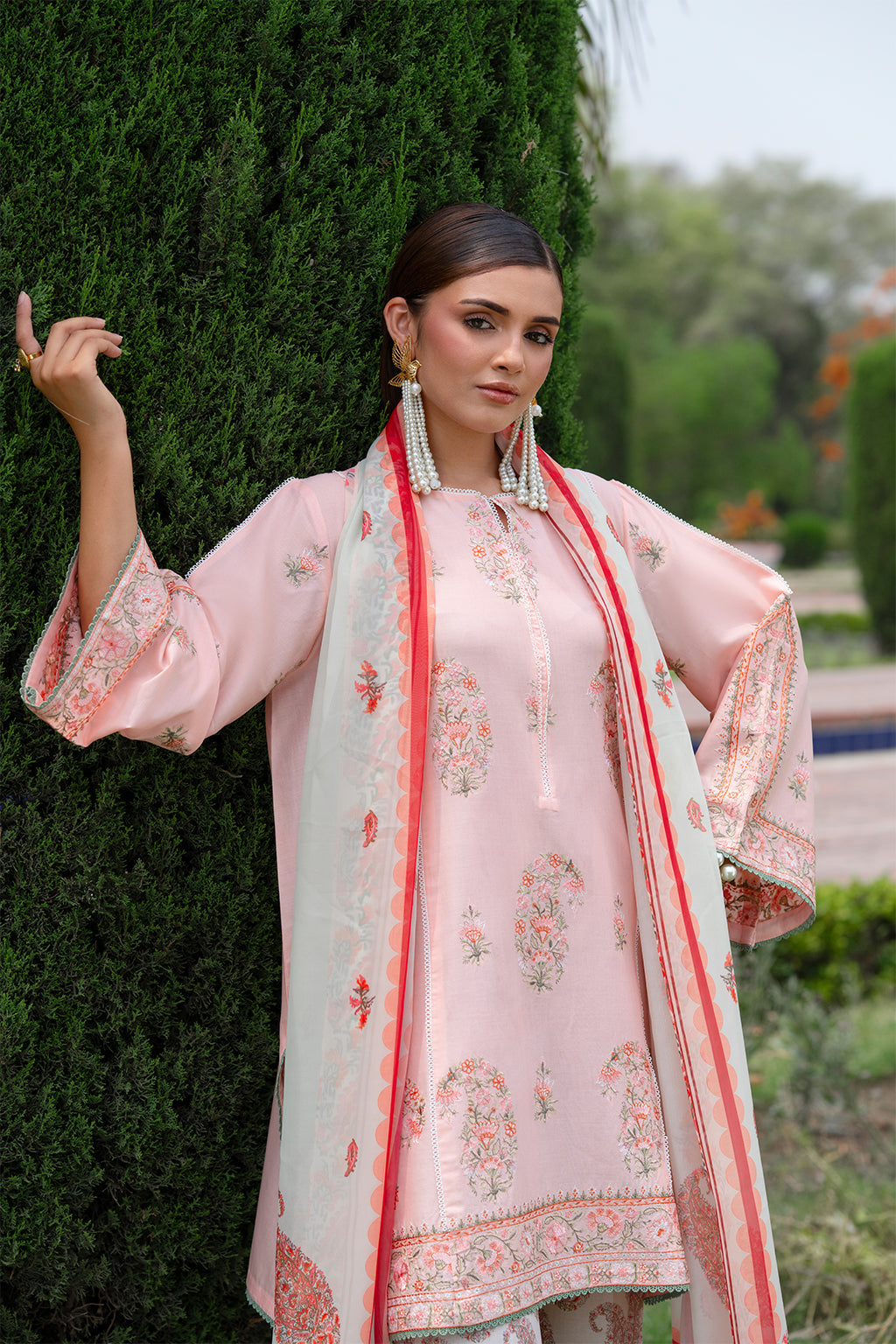 Woman in traditional outfit with floral background